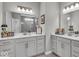 Bright bathroom featuring double sinks, framed mirrors, tile floors, and a glass walk-in shower at 6536 Apperson Dr, Noblesville, IN 46060