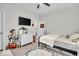Bright bedroom featuring a TV, ceiling fan, white dresser and playful decor, with an ABC rug and twin-sized bed at 6536 Apperson Dr, Noblesville, IN 46060