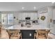 Kitchen with white cabinets, stainless steel appliances and island with seating at 6536 Apperson Dr, Noblesville, IN 46060