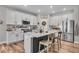 Kitchen with white cabinets, stainless steel appliances and island with barstool seating at 6536 Apperson Dr, Noblesville, IN 46060