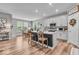Kitchen and dining area featuring hardwood floors, white cabinets, and stainless steel appliances at 6536 Apperson Dr, Noblesville, IN 46060