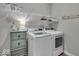 Functional laundry room featuring modern washer and dryer, storage, and wire shelving for efficient organization at 6536 Apperson Dr, Noblesville, IN 46060