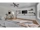 Cozy living room featuring hardwood floors, a ceiling fan, built-in entertainment center and neutral paint at 6536 Apperson Dr, Noblesville, IN 46060