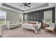 Spacious main bedroom featuring a tray ceiling, stylish accent wall, and bright windows at 6536 Apperson Dr, Noblesville, IN 46060