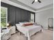 This main bedroom is complete with tray ceiling, board and batten accent wall, and lots of sunlight at 6536 Apperson Dr, Noblesville, IN 46060