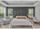 This main bedroom showcases a tray ceiling, board and batten accent wall, and plenty of natural light at 6536 Apperson Dr, Noblesville, IN 46060
