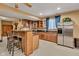 Entertain your guests in this finished basement bar area with brick accents, sink, and stainless steel refrigerator at 705 Ridge Gate Dr, Brownsburg, IN 46112