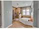 Bathroom with a glass-enclosed shower, a luxurious tub with tile surround, and tile flooring at 705 Ridge Gate Dr, Brownsburg, IN 46112