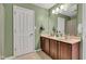 Bathroom with a double sink vanity, wooden cabinets and a large mirror at 705 Ridge Gate Dr, Brownsburg, IN 46112