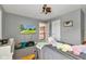 This carpeted bedroom includes a ceiling fan and television at 705 Ridge Gate Dr, Brownsburg, IN 46112