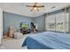Well-lit bedroom with a window, television, armchair, and a large blue bed with matching blue walls at 705 Ridge Gate Dr, Brownsburg, IN 46112