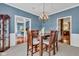 This dining room has wooden floors and an elegant table set for Gathering meals in a beautifully painted setting at 705 Ridge Gate Dr, Brownsburg, IN 46112