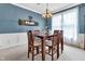 Formal dining room with seating for six and neutral decor with modern light fixtures at 705 Ridge Gate Dr, Brownsburg, IN 46112