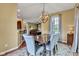 Inviting dining room featuring modern pendant lighting with views of a Gathering room and breakfast bar at 705 Ridge Gate Dr, Brownsburg, IN 46112