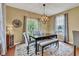 Dining room offers a dark wood table with soft seating, an area rug, and a decorative lighting fixture at 705 Ridge Gate Dr, Brownsburg, IN 46112