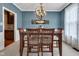 Stylish dining room with a wooden table, seating for six, and modern light fixture at 705 Ridge Gate Dr, Brownsburg, IN 46112