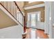 Bright foyer with hardwood floors, staircase, and a decorative glass front door at 705 Ridge Gate Dr, Brownsburg, IN 46112