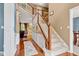Elegant foyer with hardwood flooring, staircase, and views into the adjacent living spaces at 705 Ridge Gate Dr, Brownsburg, IN 46112