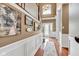 Bright foyer with hardwood floors, staircase, white trim, and ample natural light streaming through the front door window at 705 Ridge Gate Dr, Brownsburg, IN 46112