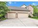 Attached three-car garage with brick exterior and large driveway at 705 Ridge Gate Dr, Brownsburg, IN 46112