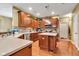 Chef's kitchen with wood cabinets, modern appliances, and ample counter space for culinary creations at 705 Ridge Gate Dr, Brownsburg, IN 46112