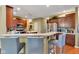 Modern kitchen boasting stainless steel appliances, an eat-in bar, and beautiful hardwood flooring at 705 Ridge Gate Dr, Brownsburg, IN 46112