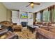 Cozy living room featuring comfortable seating, a fireplace with built-ins, and a ceiling fan for year-round comfort at 705 Ridge Gate Dr, Brownsburg, IN 46112