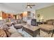Open-concept living room showcases comfortable seating, hardwood floors, neutral paint colors, and seamless flow to the kitchen at 705 Ridge Gate Dr, Brownsburg, IN 46112