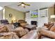 Spacious living room features a fireplace with built-in shelving, plush seating, and a patterned area rug at 705 Ridge Gate Dr, Brownsburg, IN 46112