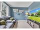 Comfortable living room features a cozy sectional sofa, blue walls, and a large TV at 705 Ridge Gate Dr, Brownsburg, IN 46112