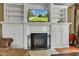 Inviting living room boasts a fireplace with custom built-ins and a mounted TV, creating a perfect space to relax at 705 Ridge Gate Dr, Brownsburg, IN 46112