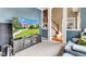 Open-concept design with stairs, television and glimpses of front yard, connecting living spaces seamlessly at 705 Ridge Gate Dr, Brownsburg, IN 46112