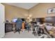 Home office setup with Titan gaming chair, multiple monitors, and ample desk space, perfect for productivity at 705 Ridge Gate Dr, Brownsburg, IN 46112