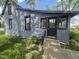 Home exterior featuring gray siding, black trim, and a concrete front porch and steps at 711 W Centennial Ave, Muncie, IN 47303