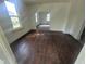 View of open living room showcasing hardwood floors, natural light, and arched doorways at 711 W Centennial Ave, Muncie, IN 47303