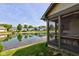 Home's screened-in porch overlooks a picturesque pond, surrounded by lush landscaping at 7150 Eagle Cove Dr, Indianapolis, IN 46254