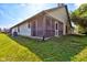 Back of home features screened-in porch, lush landscaping, and manicured lawn at 7150 Eagle Cove Dr, Indianapolis, IN 46254