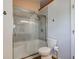 Bathroom features a sliding glass shower, decorative wall hooks, toilet and gray tiled wall at 7150 Eagle Cove Dr, Indianapolis, IN 46254