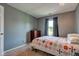 Bedroom with a view from the window, carpet, ceiling fan, and wooden dresser at 7150 Eagle Cove Dr, Indianapolis, IN 46254