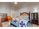 This bedroom is decorated with an ornate wooden headboard, colorful quilt and wooden dressers at 7150 Eagle Cove Dr, Indianapolis, IN 46254