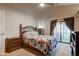 Bedroom features an ornate wooden headboard, ceiling fan and sliding doors to the outside at 7150 Eagle Cove Dr, Indianapolis, IN 46254