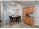 Open-concept dining room with light wood floors, wood cabinets, and modern lighting at 7150 Eagle Cove Dr, Indianapolis, IN 46254
