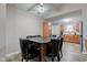 Dining room with a dark wood table and black leather chairs and modern ceiling fan at 7150 Eagle Cove Dr, Indianapolis, IN 46254