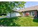 Landscaped front yard of home with a two-car garage, garden bed, and healthy green lawn at 7150 Eagle Cove Dr, Indianapolis, IN 46254
