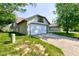 Exterior view of the attached two-car garage with a concrete driveway and well-manicured lawn at 7150 Eagle Cove Dr, Indianapolis, IN 46254