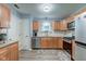 Well-lit kitchen features wood cabinets, stainless appliances, and modern countertops at 7150 Eagle Cove Dr, Indianapolis, IN 46254