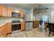 Updated kitchen with stainless steel appliances, tile backsplash, and wood cabinets at 7150 Eagle Cove Dr, Indianapolis, IN 46254
