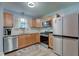 Well-lit kitchen features wood cabinets, stainless appliances, and modern countertops at 7150 Eagle Cove Dr, Indianapolis, IN 46254