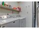 Functional laundry room featuring a modern washer and dryer, with overhead storage shelves at 7150 Eagle Cove Dr, Indianapolis, IN 46254