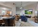 Open-concept living room with a projector and screen, and an adjoining kitchen with wood cabinets at 7150 Eagle Cove Dr, Indianapolis, IN 46254
